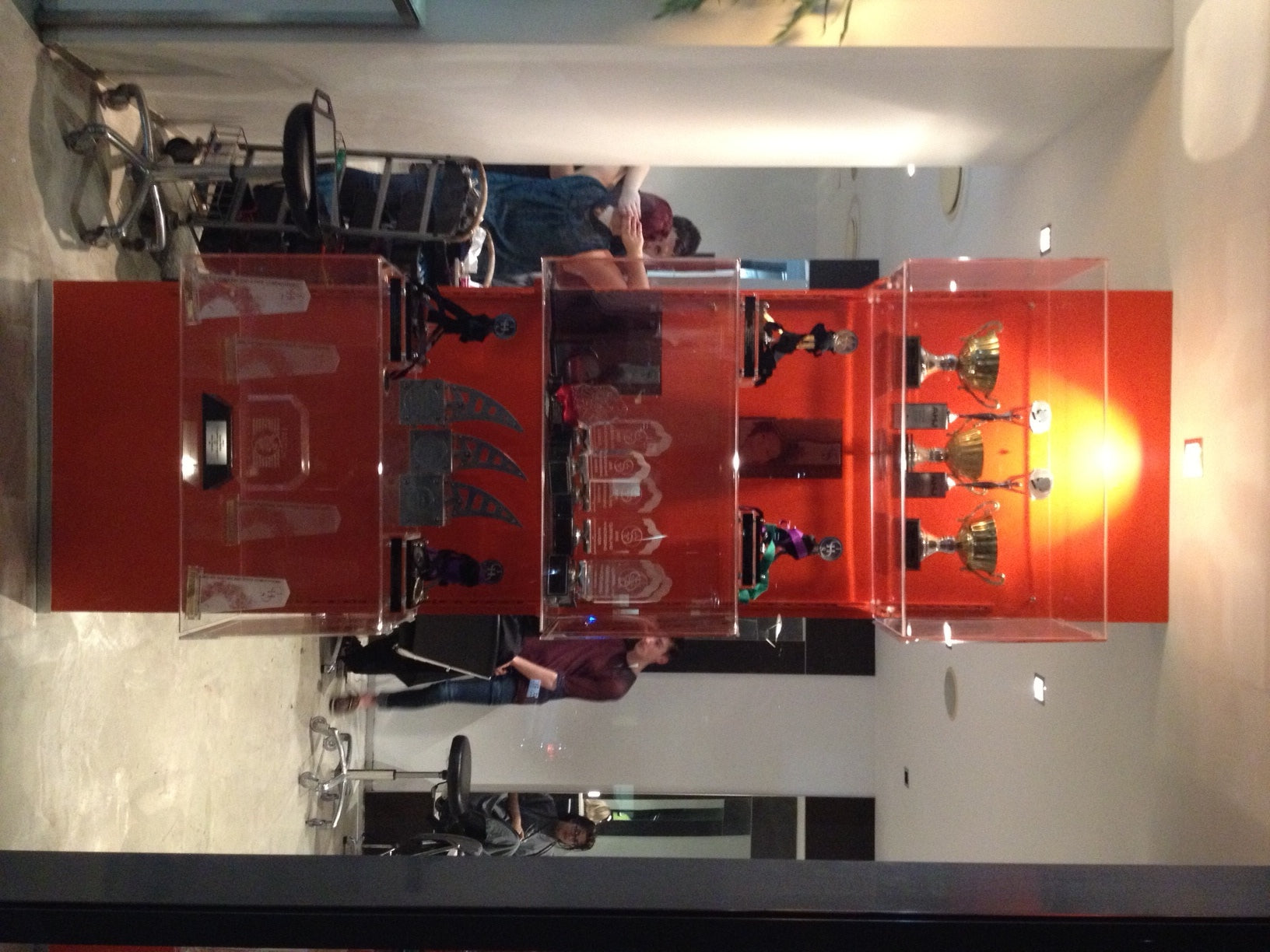 Great Visual merchandising by the VM+ team. Panels of orange and loads of trophies by Carole Haddad - legend hairdresser
